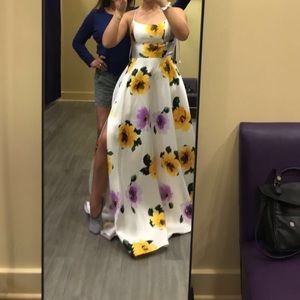 White tie back gown with yellow and purple flowers